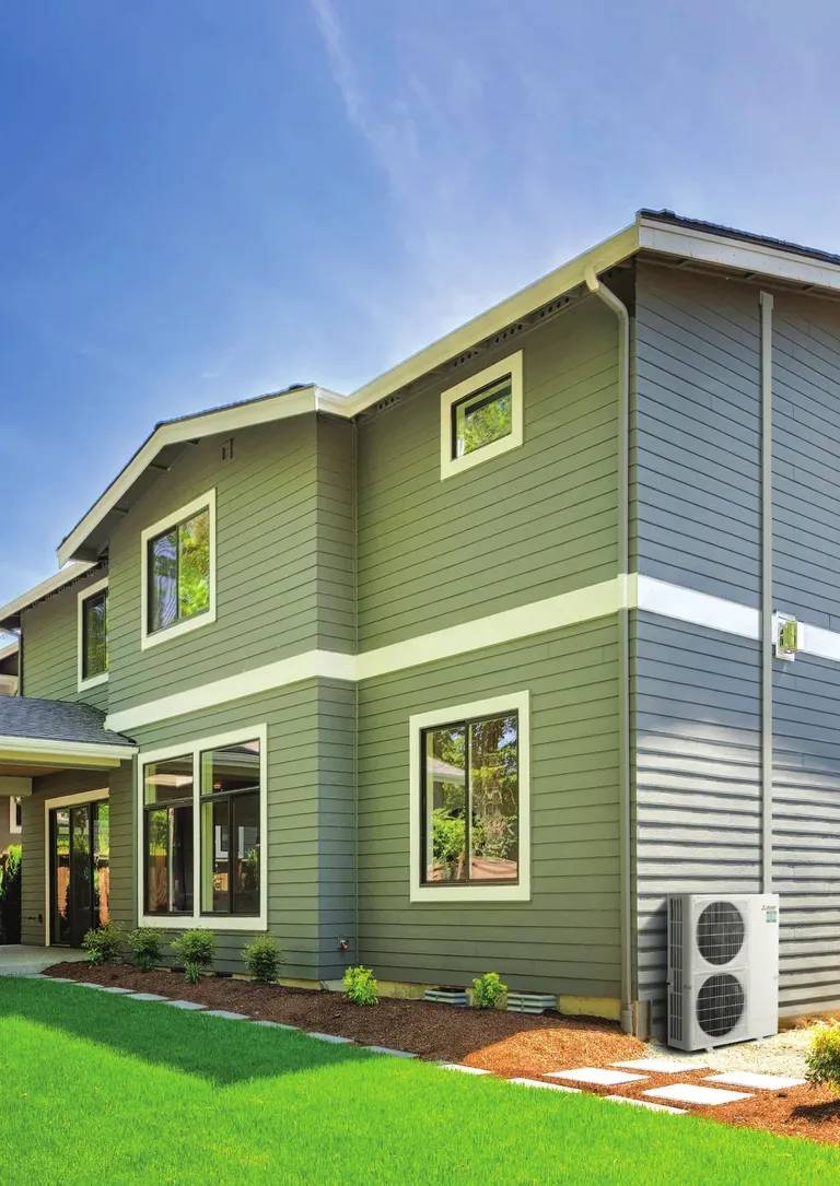 Mitsubishi Electric large capacity ducted outdoor unit beside a two-storey home